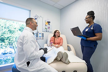 Dr. Collins with nurse and patient